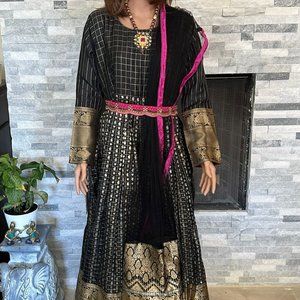 Black salwar with gold and pink borders.
